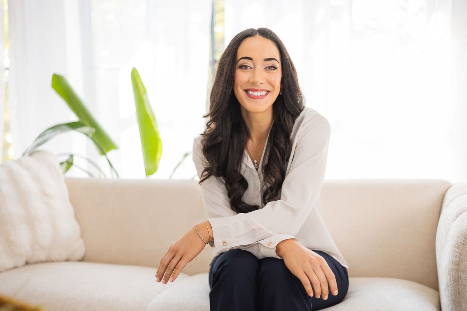 Dr. Rachel Seals — PT, DPT, NCS, founder of Movela, seated in a bright living room